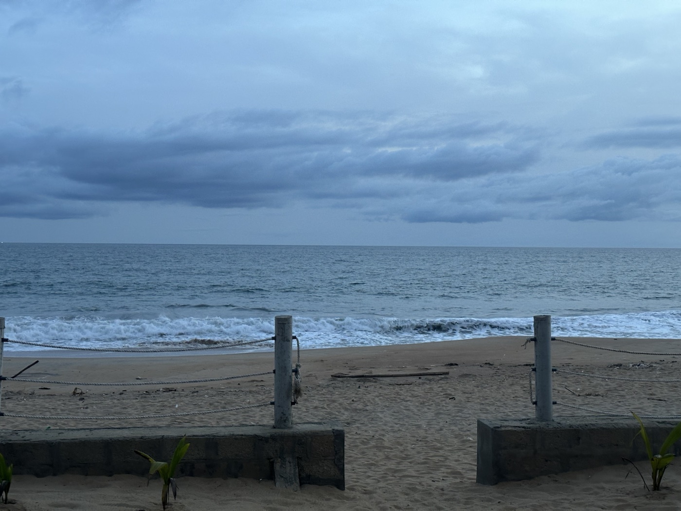 Ocean and clouded sky at dusk on a West African coast.
